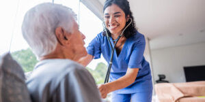 Nurse giving an in-home health assessment to a senior patient