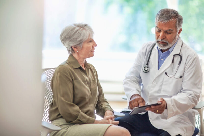 Senior woman speaks with a doctor at a clinic
